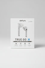 Box of Defunc True Go wireless earbuds on a beige background